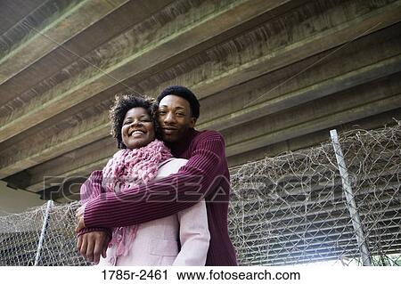 Portrait of a young couple standing under a highway overpass View Large Photo Image Stock Image - Portrait of a young couple standing under a highway overpass. Fotosearch