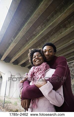Portrait of a young couple standing under a highway overpass View Large Photo Image Stock Image - Portrait of a young couple standing under a highway overpass. Fotosearch