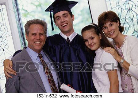 Portrait of a young man in a graduation outfit with his family View Large Photo Image Stock Image - Portrait of a young man in a graduation outfit with his family. Fotosearch