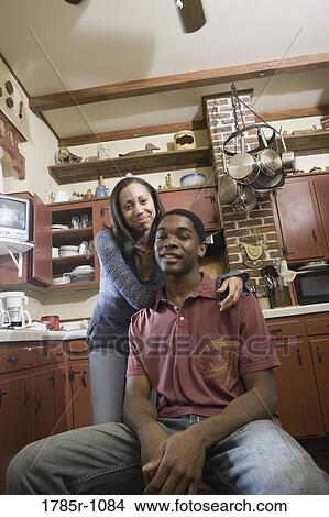 Picture - Portrait of African American brother and sister in kitchen. Fotosearch