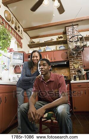 Stock Photograph - Portrait of African American brother and sister in kitchen. Fotosearch