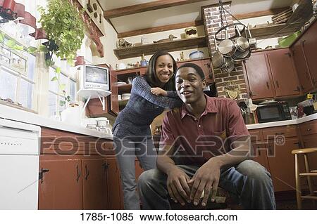 Stock Photography - Portrait of African American brother and sister in kitchen. Fotosearch