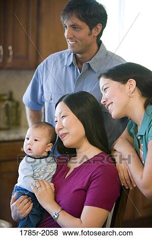 Portrait of an Asian-Caucasian family in kitchen View Large Photo Image Stock Photo - Portrait of an Asian-Caucasian family in kitchen. Fotosearch