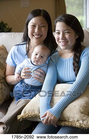 Portrait of an Asian mother with her Asian-Caucasian teenage daughter and infant boy View Large Photo Image Stock Image - Portrait of an Asian mother with her Asian-Caucasian teenage daughter and infant boy. Fotosearch