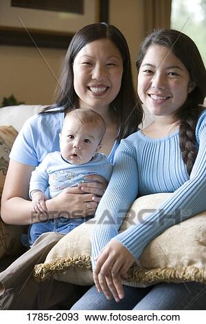 Portrait of an Asian mother with her Asian-Caucasian teenage daughter and infant boy View Large Photo Image Stock Image - Portrait of an Asian mother with her Asian-Caucasian teenage daughter and infant boy. Fotosearch
