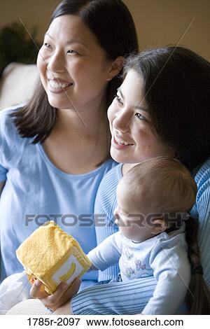 Portrait of an Asian mother with her Asian-Caucasian teenage daughter and infant boy View Large Photo Image Stock Photo - Portrait of an Asian mother with her Asian-Caucasian teenage daughter and infant boy. Fotosearch