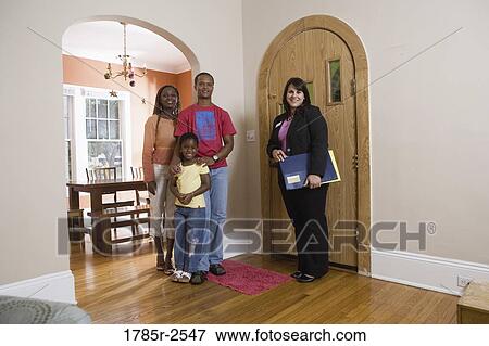Portrait of family inside house with real estate broker View Large Photo Image Stock Photo - Portrait of family inside house with real estate broker. Fotosearch