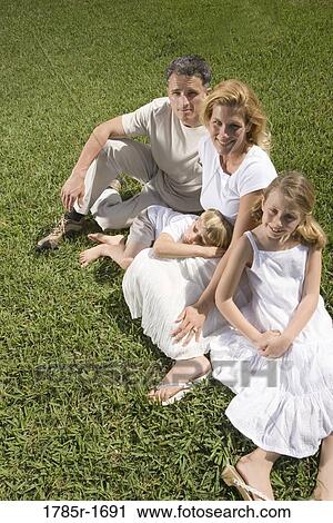 Stock Image - Portrait of family on lawn. Fotosearch