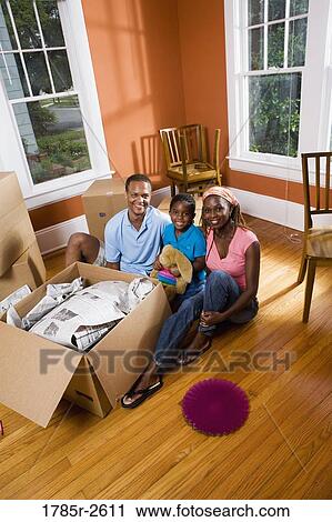 Portrait of family sitting by box View Large Photo Image Stock Image - Portrait of family sitting by box. Fotosearch