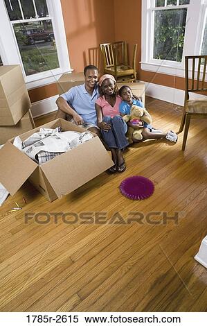 Portrait of family sitting by moving boxes View Large Photo Image Stock Photography - Portrait of family sitting by moving boxes. Fotosearch