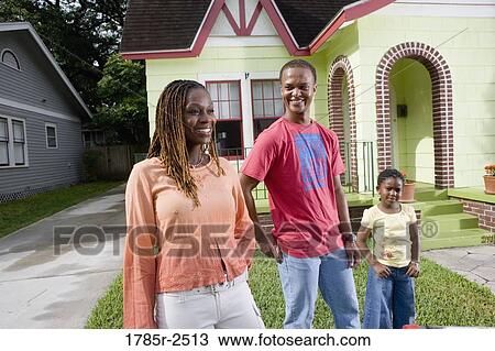 Portrait of family standing outside house View Large Photo Image Stock Image - Portrait of family standing outside house. Fotosearch