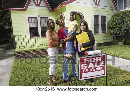 Portrait of family standing outside house with real estate broker View Large Photo Image Stock Photograph - Portrait of family standing outside house with real estate broker. Fotosearch