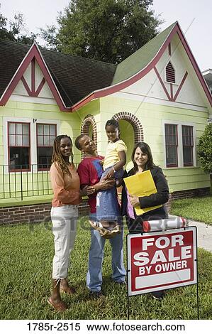 Portrait of family standing outside house with real estate broker View Large Photo Image Stock Photography - Portrait of family standing outside house with real estate broker. Fotosearch