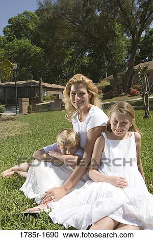 Portrait of mother and children on lawn View Large Photo Image Stock Image - Portrait of mother and children on lawn. Fotosearch