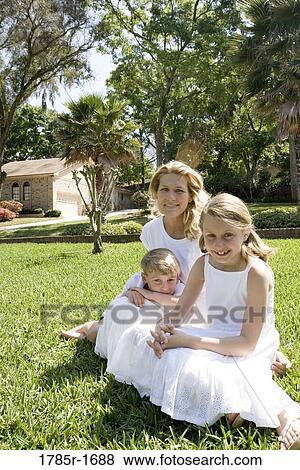 Portrait of mother and children on lawn View Large Photo Image Stock Photo - Portrait of mother and children on lawn. Fotosearch