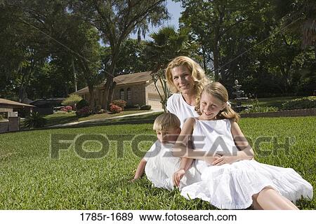 Portrait of mother and children on lawn View Large Photo Image Stock Photo - Portrait of mother and children on lawn. Fotosearch