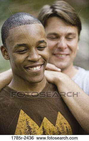 Portrait of two young men, a gay couple, smiling View Large Photo Image Stock Photograph - Portrait of two young men, a gay couple, smiling. Fotosearch
