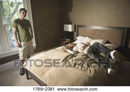 Portrait of two young men in a bedroom View Large Photo Image Stock Image - Portrait of two young men in a bedroom. Fotosearch