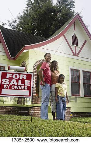 Portrait of young family standing outside house by "For Sale" sign View Large Photo Image Stock Image - Portrait of young family standing outside house by "For Sale" sign. Fotosearch