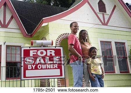 Portrait of young family standing outside house by "For Sale" sign View Large Photo Image Stock Image - Portrait of young family standing outside house by "For Sale" sign. Fotosearch