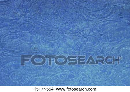 Rain falling on the surface of water View Large Photo Image Picture - Rain falling on the surface of water. Fotosearch