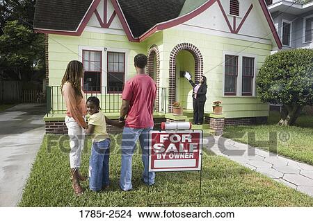 Picture - Real estate broker showing house to buyers. Fotosearch