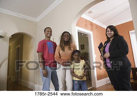 Picture - Real estate broker showing house to buyers. Fotosearch