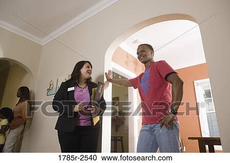 Real estate broker showing house to buyers View Large Photo Image Stock Image - Real estate broker showing house to buyers. Fotosearch