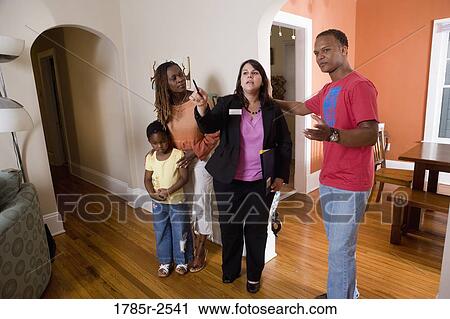 Real estate broker showing house to buyers View Large Photo Image Stock Image - Real estate broker showing house to buyers. Fotosearch