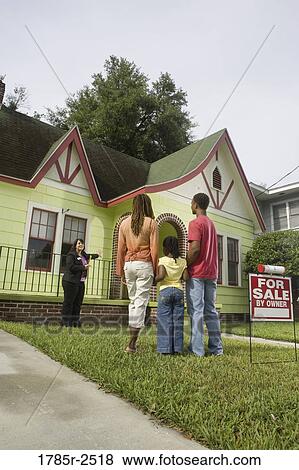 Real estate broker showing house to buyers View Large Photo Image Stock Photo - Real estate broker showing house to buyers. Fotosearch