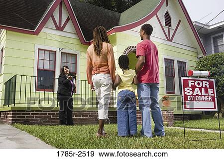 Real estate broker showing house to buyers View Large Photo Image Stock Photo - Real estate broker showing house to buyers. Fotosearch