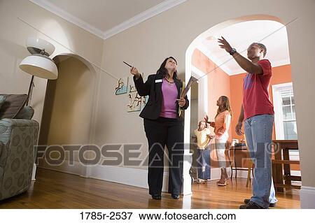Real estate broker showing house to buyers View Large Photo Image Stock Photo - Real estate broker showing house to buyers. Fotosearch
