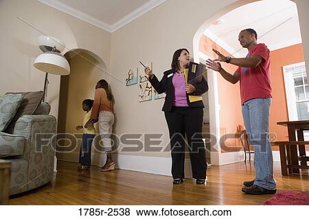 Real estate broker showing house to buyers View Large Photo Image Stock Photo - Real estate broker showing house to buyers. Fotosearch