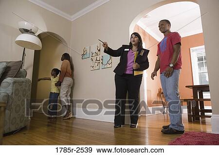 Real estate broker showing house to buyers View Large Photo Image Stock Photo - Real estate broker showing house to buyers. Fotosearch