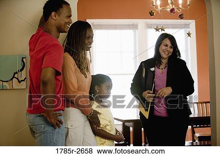 Real estate broker showing house to buyers View Large Photo Image Stock Photo - Real estate broker showing house to buyers. Fotosearch