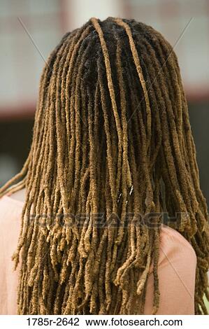 Stock Image - Rear view of woman with dreadlocks. Fotosearch