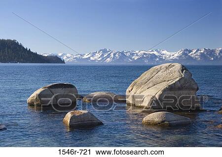 Rock formations in a lake with mountains in the background, Lake Tahoe, Nevada, USA View Large Photo Image Stock Image - Rock formations in a lake with mountains in the background, Lake Tahoe, Nevada, USA. Fotosearch