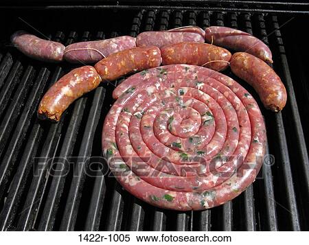 Stock Photography - Sausages on an outdoor grill. Fotosearch