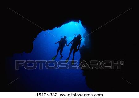 Stock Image - Scuba divers underwater. Fotosearch