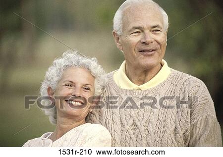 Stock Image - Senior couple looking ahead smiling. Fotosearch