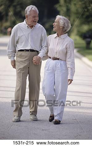 Senior couple walking outdoors holding hands View Large Photo Image Stock Photography - Senior couple walking outdoors holding hands. Fotosearch