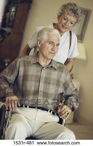 Senior woman pushing a senior man in a wheelchair View Large Photo Image Stock Image - Senior woman pushing a senior man in a wheelchair. Fotosearch