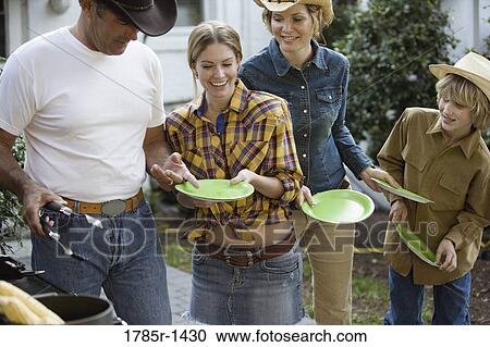 Serving food off the grill to family View Large Photo Image Stock Image - Serving food off the grill to family. Fotosearch
