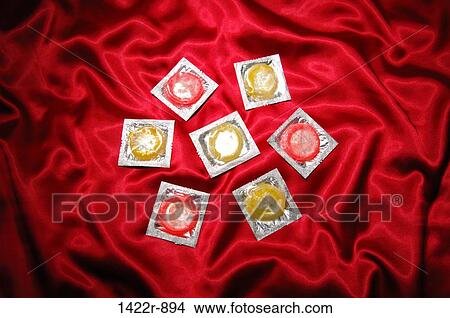 Seven condoms on red satin sheets View Large Photo Image Picture - Seven condoms on red satin sheets. Fotosearch