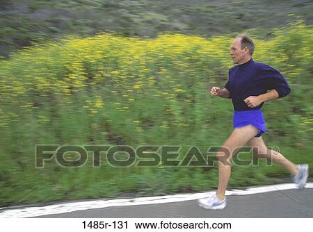 Stock Image - Side profile of a man running. Fotosearch