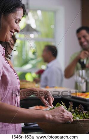 Side profile of a mature woman mixing salad in a mixing bowl View Large Photo Image Stock Image - Side profile of a mature woman mixing salad in a mixing bowl. Fotosearch