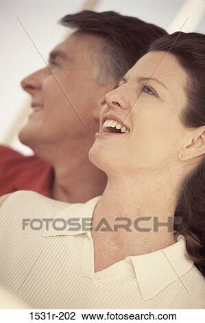 Side profile of a mid adult couple smiling View Large Photo Image Stock Image - Side profile of a mid adult couple smiling. Fotosearch