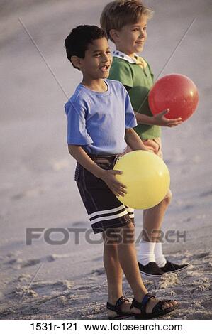 Side profile of two boys holding balls View Large Photo Image Stock Image - Side profile of two boys holding balls. Fotosearch