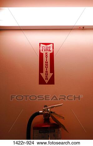 Sign pointing to fire extinguisher in hallway View Large Photo Image Picture - Sign pointing to fire extinguisher in hallway. Fotosearch