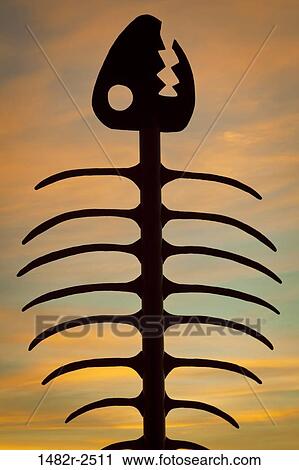 Stock Image - Silhouette of a fishbone sculpture, Embarcadero Marina Park, Seaport Village, San Diego, California, USA. Fotosearch